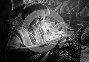 Vietnamese fishermen are doing basketry for fishing equipment at photo