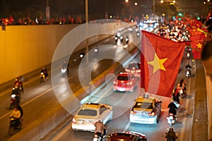 Vietnamese flags with crowd of Vietname football fans down the street to celebrate the win after soccer