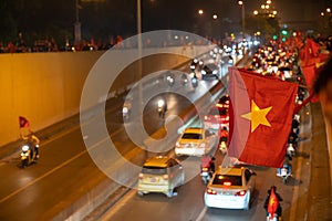 Vietnamese flags with crowd of Vietname football fans down the street to celebrate the win after soccer