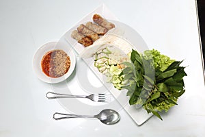 Vietnamese Food in Restaurant white plate on the Table with side dish, Ingredients of Vietnamese Wraps or Pork Sausage, Nam Naung