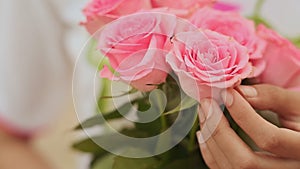 Vietnamese girl holding a bouquet of pink roses