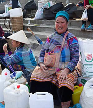 Vietnamese Hmong women selling traditional wine in canes