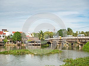 Vietnamese houses on a river, floating market and boats, traditional way of life, Hoi An town, central Vietnam