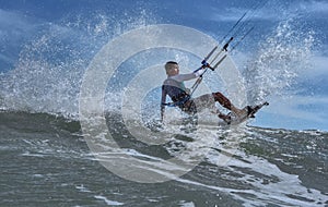 Vietnamese kite surfer jumps with kiteboard photo