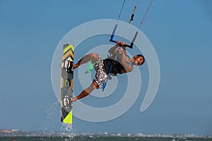 Vietnamese kite surfer jumps with kiteboard photo