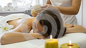 Vietnamese massage with herbal compresses at the beauty shop