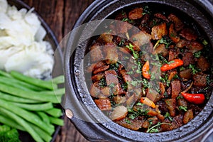 Vietnamese meal for vegetarian, plate of boiled vegetables, vegan braised sauce in pot with rice