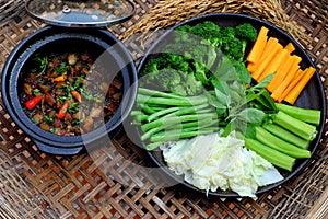 Vietnamese meal for vegetarian, plate of boiled vegetables, vegan braised sauce in pot with rice