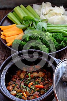 Vietnamese meal for vegetarian, plate of boiled vegetables, vegan braised sauce in pot with rice