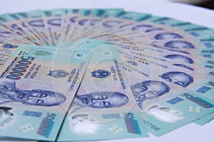 Vietnamese money on white table. VND. Just printed asian money. Asian money fan out. Concept of rich and sucsess.