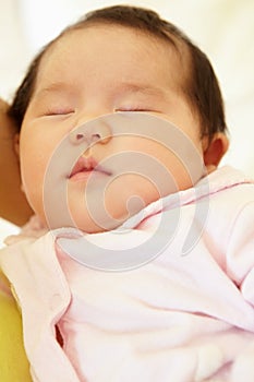 Vietnamese mother cuddling baby