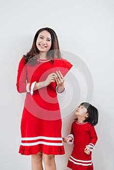 Vietnamese mother and daughter celebrate new year at home. Tet H