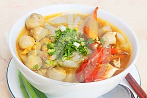 Vietnamese noodle with crab and mushroom or banh canh cua in white bowl