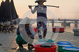 Vietnamese people selling fish