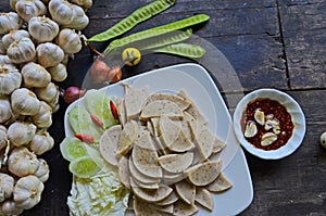 Vietnamese pork sausage dish and chili sauce on the table