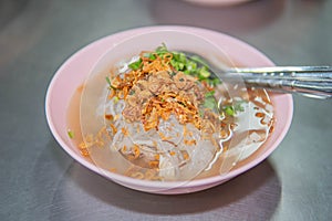 Vietnamese Rice Noodles Soup with pork spare ribs holding in fork and Vietnamese style sausage,