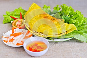 Vietnamese rice pancake with fish sauce, tomato and fermented ca