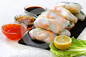 Vietnamese spring rolls - rice paper, lettuce, salad, vermicelli, noodles, shrimps, fish sauce, sweet chili, soy, lemon