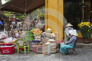 Vietnamese street vendor sells local food on the street in Hoi An, Vietnam