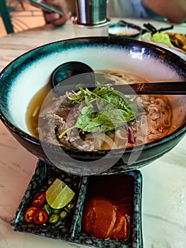 Vietnamese style noodle served with large spoon