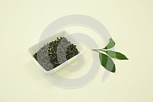 Vietnamese tea. Green Tea Phat Do. Lemon leaf. Isolated in a white bowl on a white background