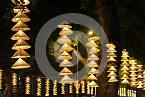 Vietnamese traditional conical hats hanging on wire for decoration.