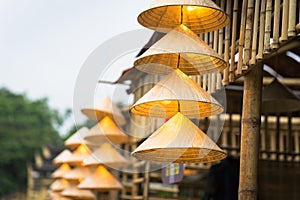 Vietnamese traditional conical hats hanging on wire for decoration.