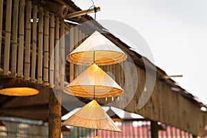 Vietnamese traditional conical hats hanging on wire for decoration.