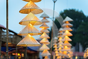 Vietnamese traditional conical hats hanging on wire for decoration.