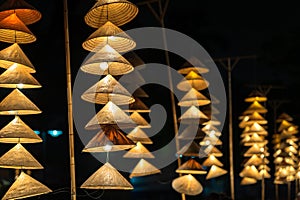 Vietnamese traditional conical hats hanging on wire for decoration.