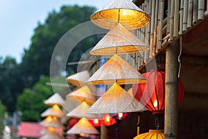 Vietnamese traditional conical hats hanging on wire for decoration.