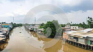 Vietnamese Traditional Houses Along River In Mekong Delta, Vietnam.