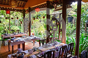 Vietnamese typical outdoor restaurant with laid tables in the green near Hue, Vietnam