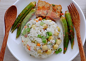 Vietnamese vegan food with fried rice and lotus seed, okra, tofu pie, simple vegetarian meal for non meat diet