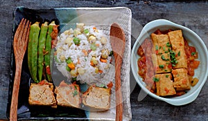 Vietnamese vegan food with fried rice and lotus seed, okra, tofu pie, simple vegetarian meal for non meat diet