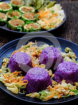 Vietnamese vegetarian eating, grilled vegetables, winter melon stuff with tofu, carrot, violet rice dish