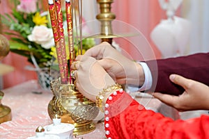 Vietnamese wedding bride and groom offered incense to the ancestor altar