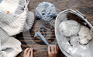 Vietnamese woman hands knitting woollen sweater, knit at home to make handicraft clothing