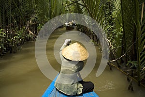 Vietnamese woman rowing a boat