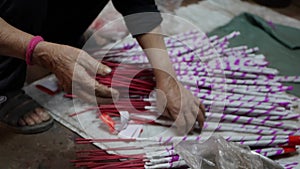 Vietnamese woman weighs, packs and puts out newly made incense sticks for shipment to stores. Production manufacture of