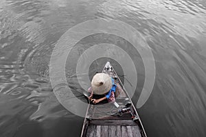 Vietnamese woman on wooden boat