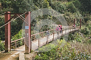 Vietnamese women from the Northern tribe of Vietnam are on the bridge. Red Dao is one of the minority ethnic groups in Vietnam