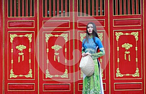 Vietnamese women wear Ao dai and non la