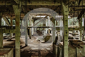 View of abandoned empty buildings of old tin mine. Industrial dirty building interior. Damaged factory in Rolava, Ore mountains,