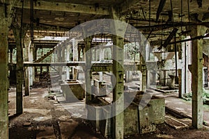 View of abandoned empty buildings of old tin mine. Industrial dirty building interior. Damaged factory in Rolava, Ore mountains,