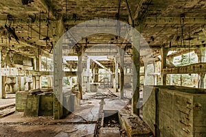 View of abandoned empty buildings of old tin mine. Industrial dirty building interior. Damaged factory in Rolava, Ore mountains,