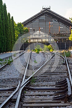 View of abandoned train tracks with Delicias station in the background, in Madrid, Spain