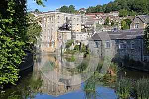 View of Abbey Mill building on river Avon with Tory neighborhood in the background, Bradford on Avon, UK