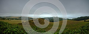 View from Abbotsbury Hill over St Catherine's Church in Abbotsbury with the Swannery and Fleet of Chesil Beach in the background,