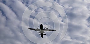 View from above on airplane in flight. Aircraft is flying in blue cloudy sky. Original sound.